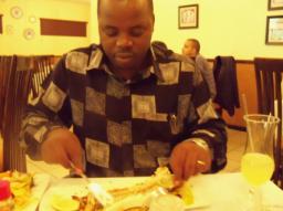 Pastor Matthews eating fish